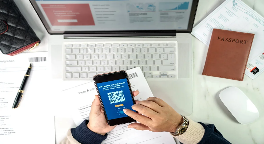 Traveler planning a trip with passport and boarding pass